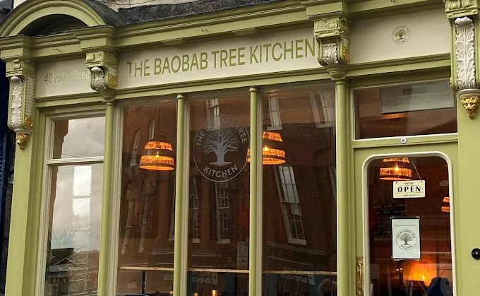 picture of shopfont painted green and white