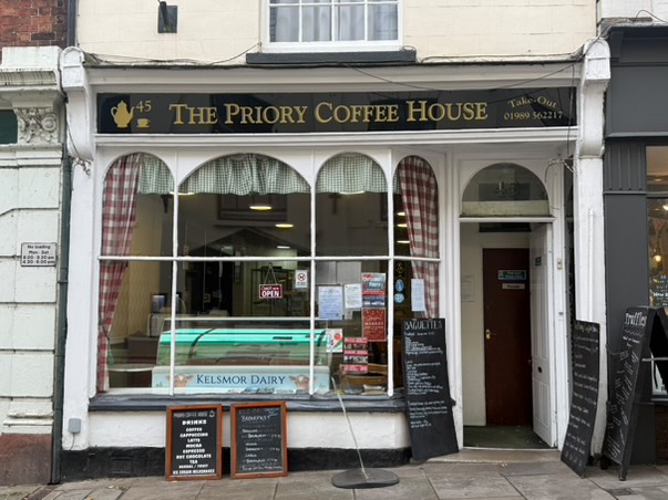 picture of shopfront with black banner and gold text at the top
