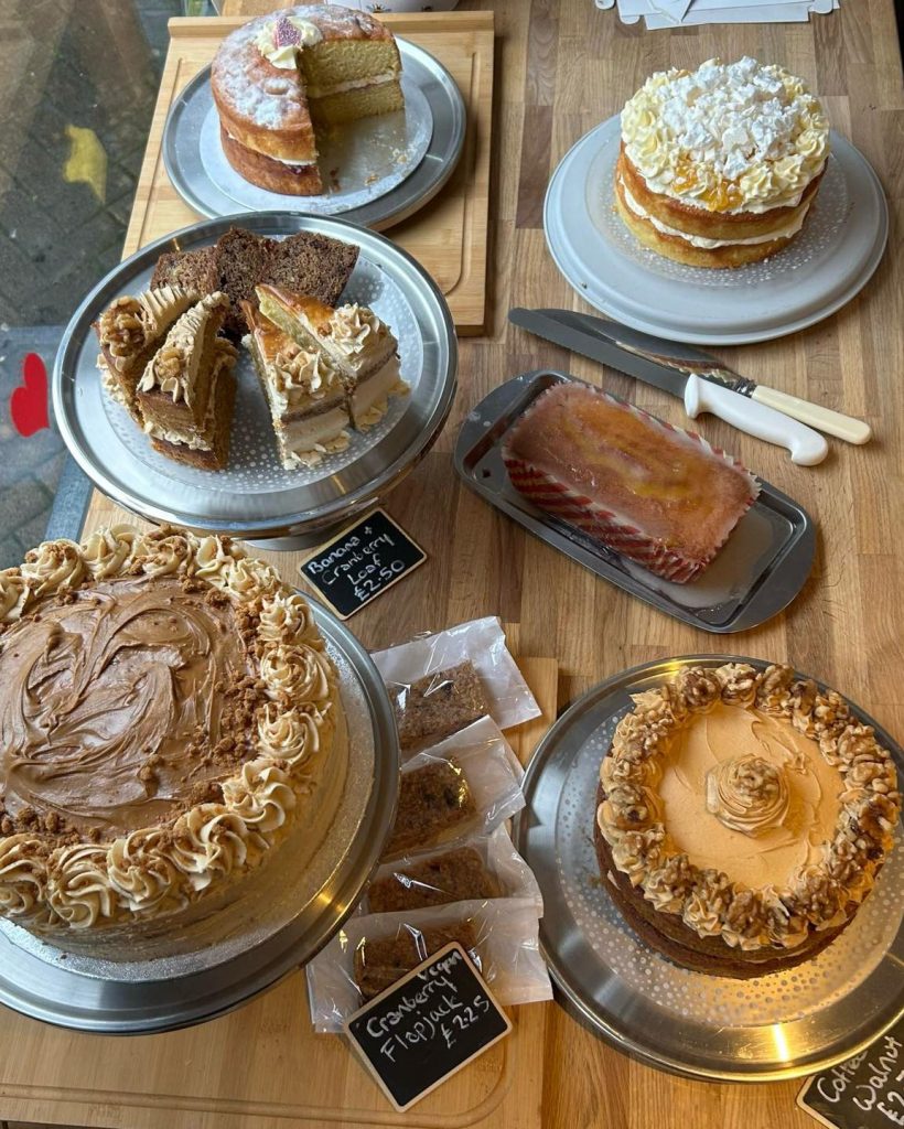 picture from above of a variety of cakes on wooden top table
