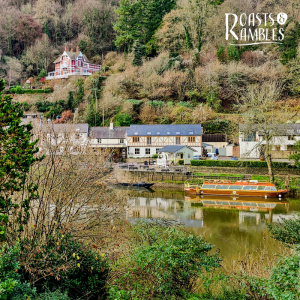 picture of white and timber framed buildings along roiver bank, taken from opposite side of river
