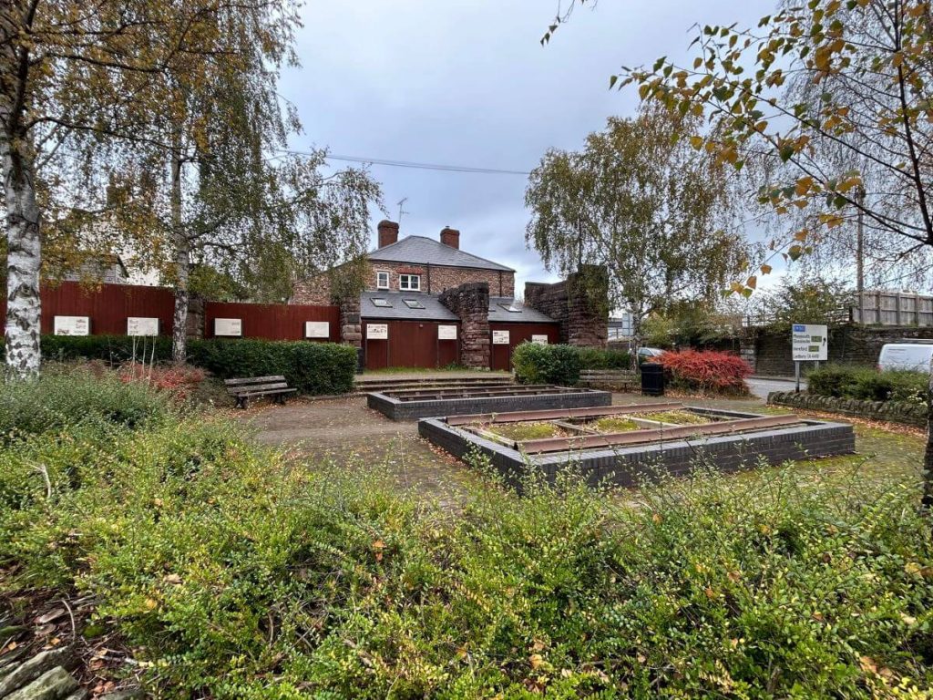 Picture of gardens with brick surronded low plots in centre