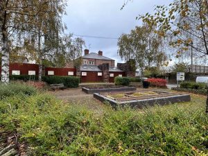 Picture of gardens with brick surronded low plots in centre